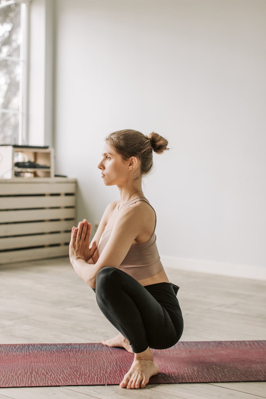 A serene woman practicing a breathing exercise in a bright, peaceful room.